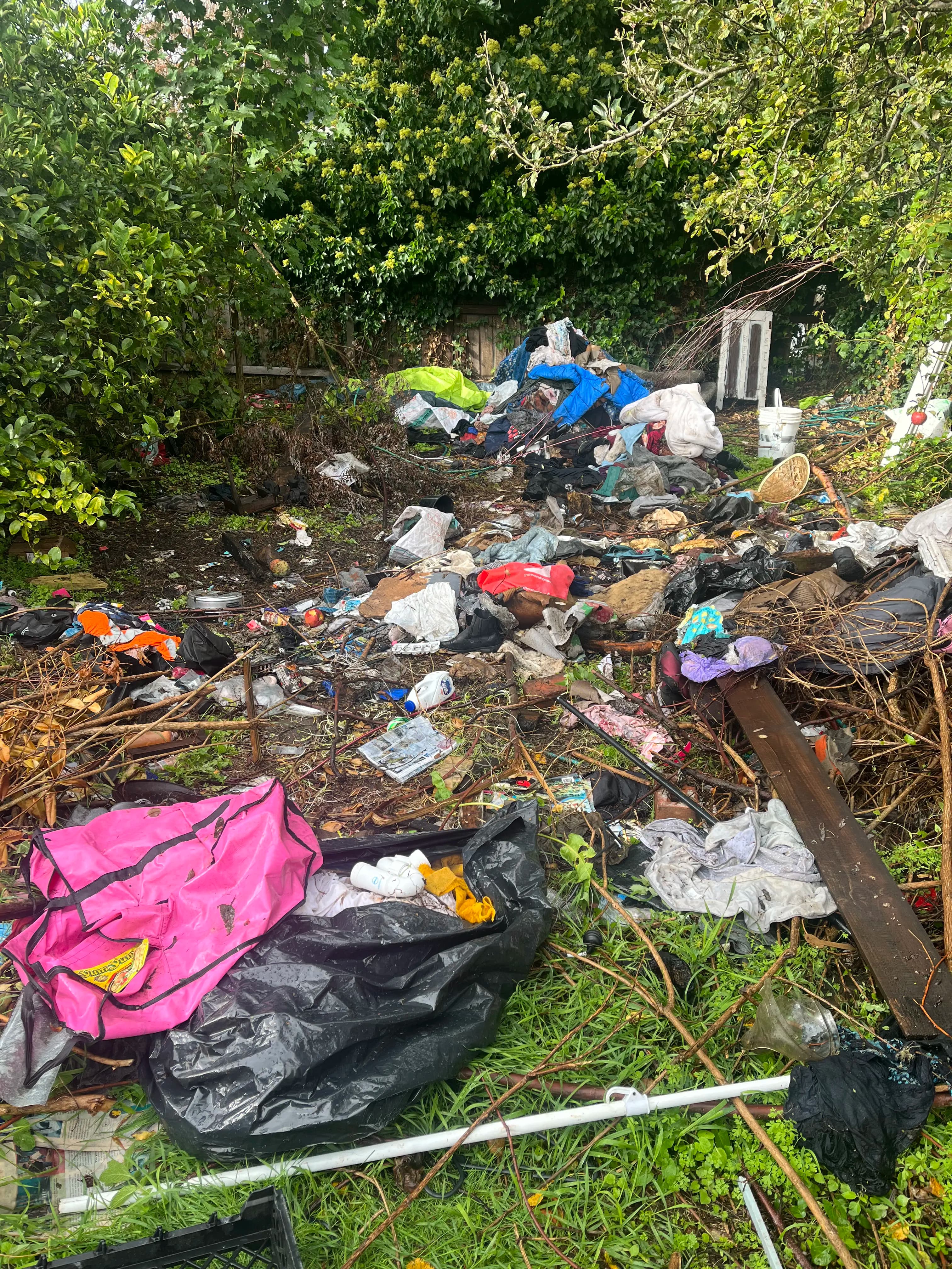 Before junk removal in Christchurch - cluttered backyard with unwanted items and debris